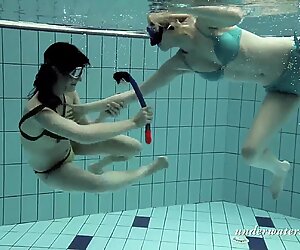 Girls swimming underwater and enjoying eachother